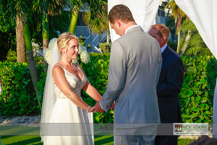 holding hands, ceremony, looking into eyes, beach wedding photography, Sanibel, lawn, tent, marquee